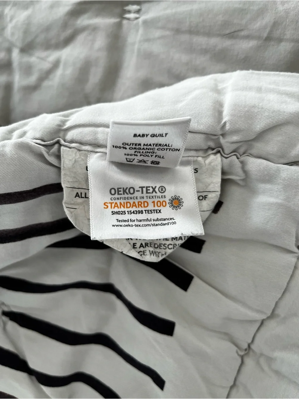Lovevery organic comforter with animals and stripes